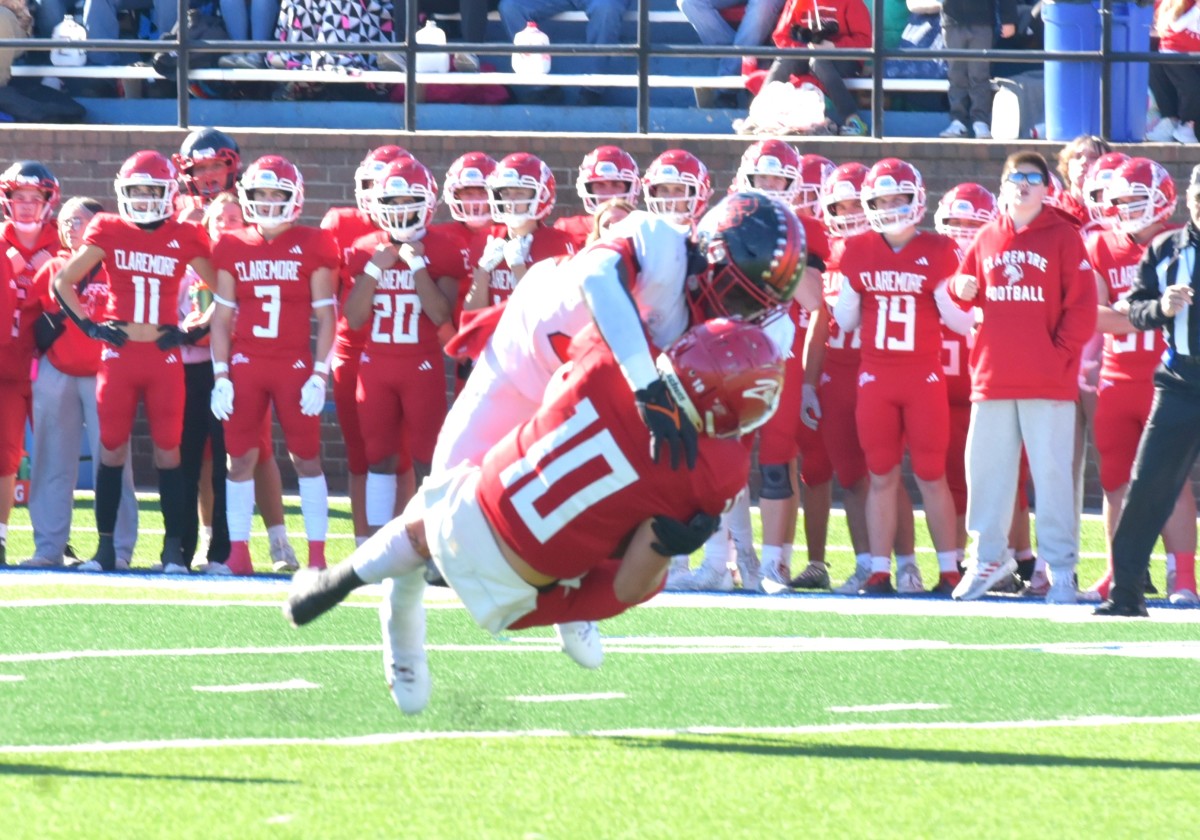 Del City's Ricklan Holmes (top) delivers a sack during the Eagles' Class 5A semifinal win against Claremore on Nov. 24, 2023.